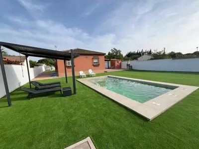 a backyard with a swimming pool and a gazebo at Chalet Wanderlust in Chiclana de la Frontera
