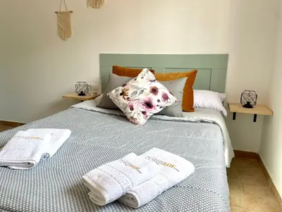 a bedroom with a bed with towels on it at Chalet Wanderlust in Chiclana de la Frontera