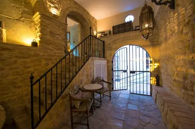 a stone hallway with a table and stairs in a building at La Vista de Medina Studios & Apartments in Medina Sidonia