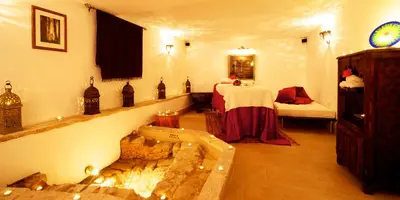 a bedroom with a bed and a tub in a room at La Vista de Medina Studios & Apartments in Medina Sidonia