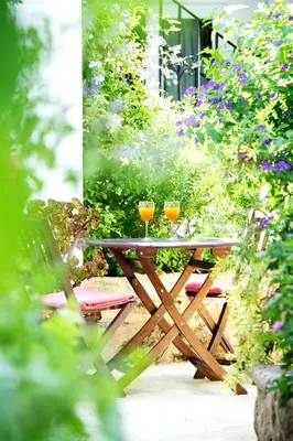 two glasses of wine sitting on a wooden table at La Vista de Medina Studios & Apartments in Medina Sidonia