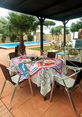 a table with plates of food on it on a patio at Villa Lola 14 in Chiclana de la Frontera