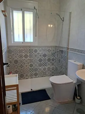a bathroom with a toilet and a shower and a sink at Villa Lola 14 in Chiclana de la Frontera