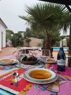 a table with plates of food and a bottle of wine at Villa Lola 14 in Chiclana de la Frontera