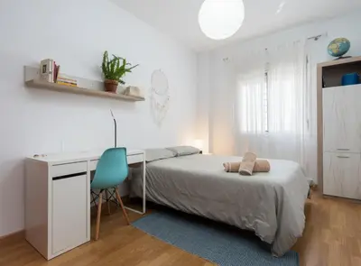 a bedroom with a bed and a desk and a chair at Apartoyou - Plaza San Juan in El Puerto de Santa María
