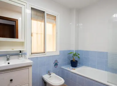 a bathroom with a sink and a toilet and a tub at Apartoyou - Plaza San Juan in El Puerto de Santa María