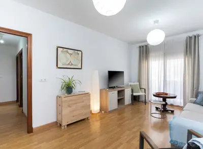 a living room with a couch and a tv at Apartoyou - Plaza San Juan in El Puerto de Santa María