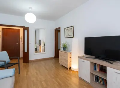 a living room with a large flat screen tv at Apartoyou - Plaza San Juan in El Puerto de Santa María