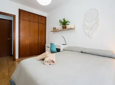 a bedroom with a bed with a towel on it at Apartoyou - Plaza San Juan in El Puerto de Santa María
