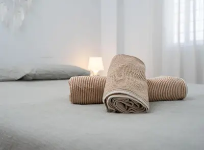 a brown blanket sitting on the floor in a bedroom at Apartoyou - Plaza San Juan in El Puerto de Santa María