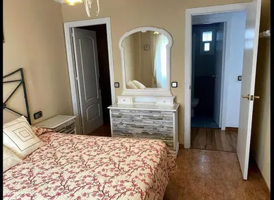a bedroom with a bed and a large mirror at Excelente piso en San Fernando in San Fernando