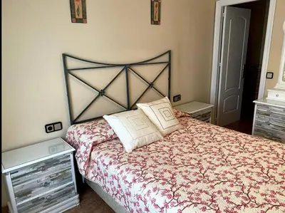 a bedroom with a large bed with a floral bedspread at Excelente piso en San Fernando in San Fernando