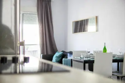 a living room with a table and a dining room at Apartamento Piletas in Sanlúcar de Barrameda