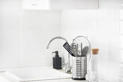 a kitchen counter with a sink with a kitchen utensils at Apartamento Piletas in Sanlúcar de Barrameda