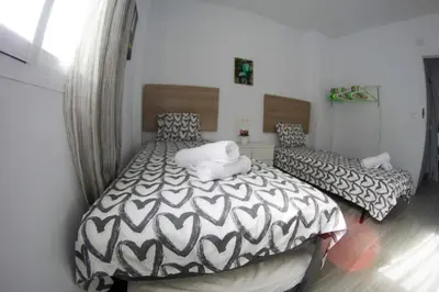 a bedroom with two beds in a room at Apartamento Piletas in Sanlúcar de Barrameda