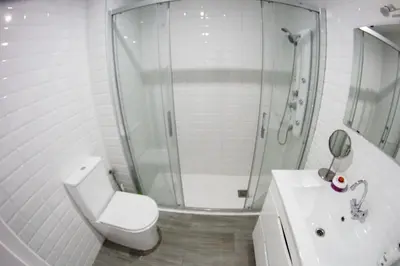 a bathroom with a shower and a toilet and a sink at Apartamento Piletas in Sanlúcar de Barrameda