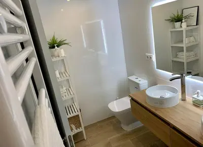 a bathroom with a sink and a toilet and a mirror at Azvalia - Valdelagrana Mirador de la Bahía, Playa, piscina, parking, vistas ! in El Puerto de Santa María