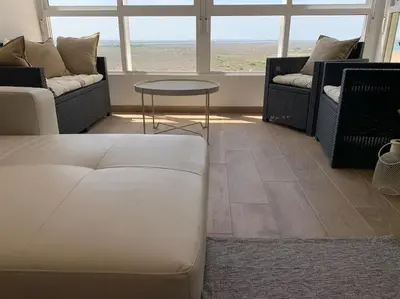 a living room with two couches and a table at Azvalia - Valdelagrana Mirador de la Bahía, Playa, piscina, parking, vistas ! in El Puerto de Santa María