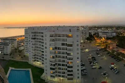 an aerial view of a large white building with a parking lot at Azvalia - Valdelagrana Mirador de la Bahía, Playa, piscina, parking, vistas ! in El Puerto de Santa María