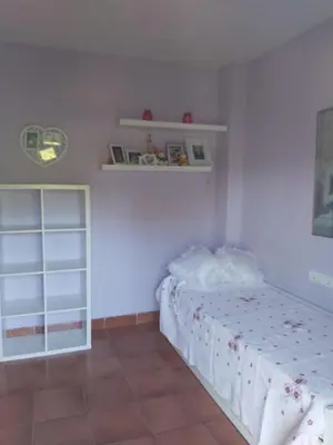 a white bedroom with a bed and a shelf at VILLA DEL MAR in Novo Sancti Petri