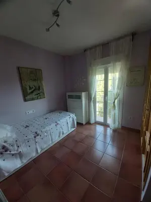 a bedroom with a bed and a tiled floor at VILLA DEL MAR in Novo Sancti Petri