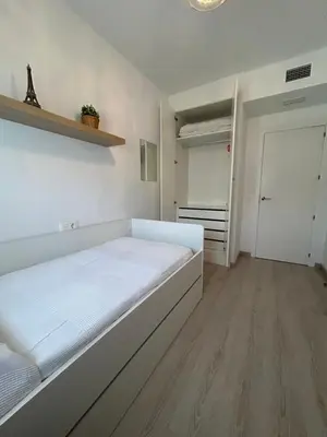a white bedroom with a bed and a closet at BAJO GUÍA DELUXE in Sanlúcar de Barrameda
