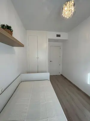 a white bedroom with a bed in a room at BAJO GUÍA DELUXE in Sanlúcar de Barrameda
