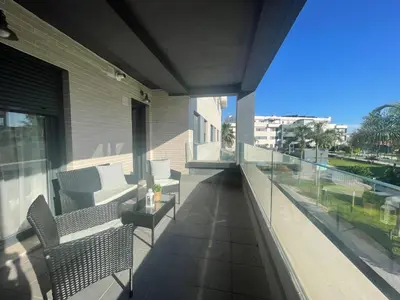 a balcony with two benches and a view of a building at BAJO GUÍA DELUXE in Sanlúcar de Barrameda