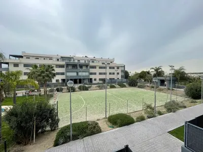a large building with a soccer field in front of it at BAJO GUÍA DELUXE in Sanlúcar de Barrameda