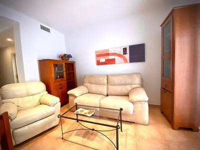 a living room with a couch and a coffee table at MyChoice Dadim in Rota