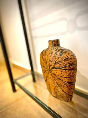 a vase sitting on top of a glass table at MyChoice Dadim in Rota