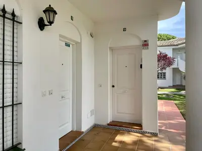 a hallway of a house with a white door at Apartamento Columela in Chiclana de la Frontera