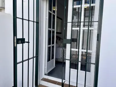 an open door to a room with a balcony at Apartamento Columela in Chiclana de la Frontera