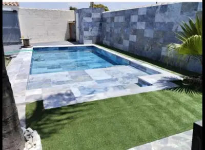 a swimming pool in the yard of a house at VILLA ESTRELLA in Inmaculada