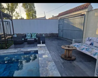 a patio with a pool with a table and a bench at VILLA ESTRELLA in Inmaculada
