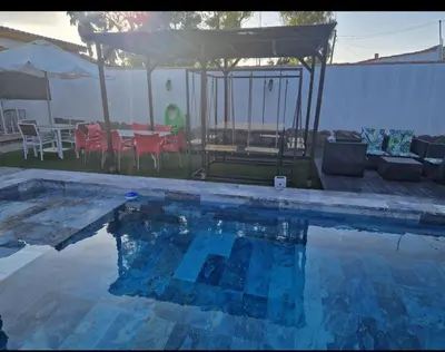 a swimming pool with a gazebo and a table and chairs at VILLA ESTRELLA in Inmaculada