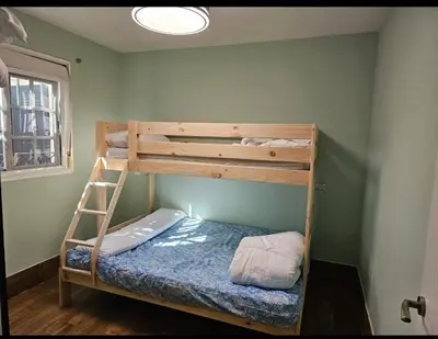 a bunk bed in a room with a ladder at VILLA ESTRELLA in Inmaculada