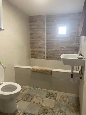 a bathroom with a toilet and a sink and a tub at Apartamentos Arquillo de Rota in Sanlúcar de Barrameda