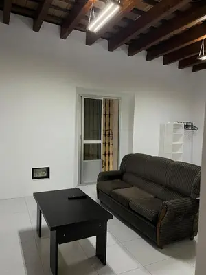a living room with a couch and a coffee table at Apartamentos Arquillo de Rota in Sanlúcar de Barrameda
