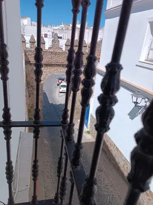a view of a street from the balcony of a building at Apartamentos Arquillo de Rota in Sanlúcar de Barrameda