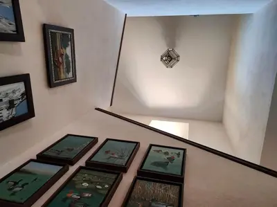 a group of framed pictures on a stair case at Casa de campo - Cortijo El Palomar in Alcántara