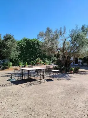 a group of tables and chairs in a park at Casa de campo - Cortijo El Palomar in Alcántara