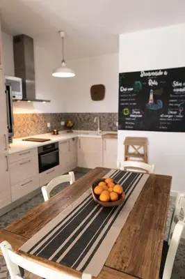 a bowl of oranges on a wooden table in a kitchen at Rosario17 by 7Escalones in Rota