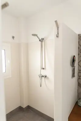 a shower stall in a bathroom with white walls at Rosario17 by 7Escalones in Rota