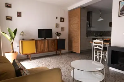 a living room with a couch and a tv and a table at Rosario17 by 7Escalones in Rota