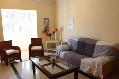 a living room with a couch and a glass table at Chalet Violeta in Chiclana de la Frontera