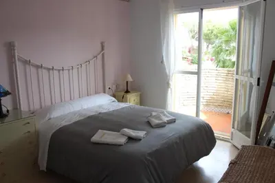 a bedroom with a bed with two towels on it at Chalet Violeta in Chiclana de la Frontera