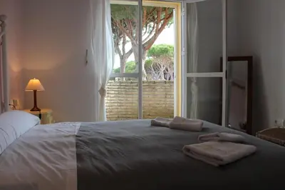 a bedroom with a bed with two towels on it at Chalet Violeta in Chiclana de la Frontera