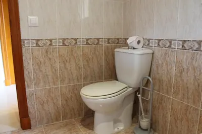 a bathroom with a toilet with a roll of toilet paper at Chalet Violeta in Chiclana de la Frontera