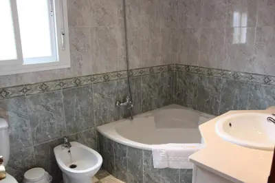 a bathroom with a tub and a sink and a toilet at Chalet Violeta in Chiclana de la Frontera